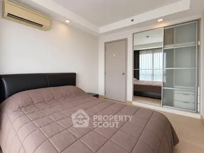 Modern bedroom with air conditioning and sliding closet doors in a stylish apartment.