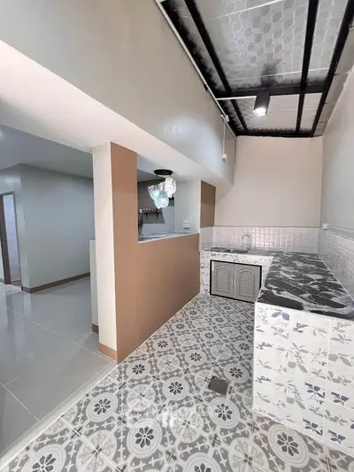 Charming kitchen with unique tile flooring and open layout, perfect for modern living.