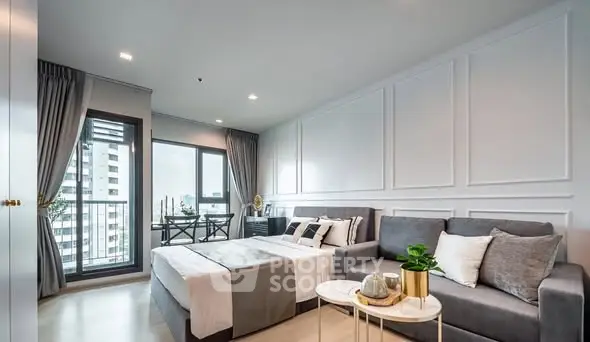 Modern studio apartment with stylish decor and city view balcony.