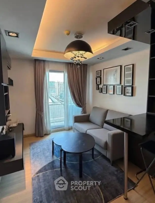 Modern living room with stylish decor and city view from balcony, featuring cozy seating and elegant lighting.