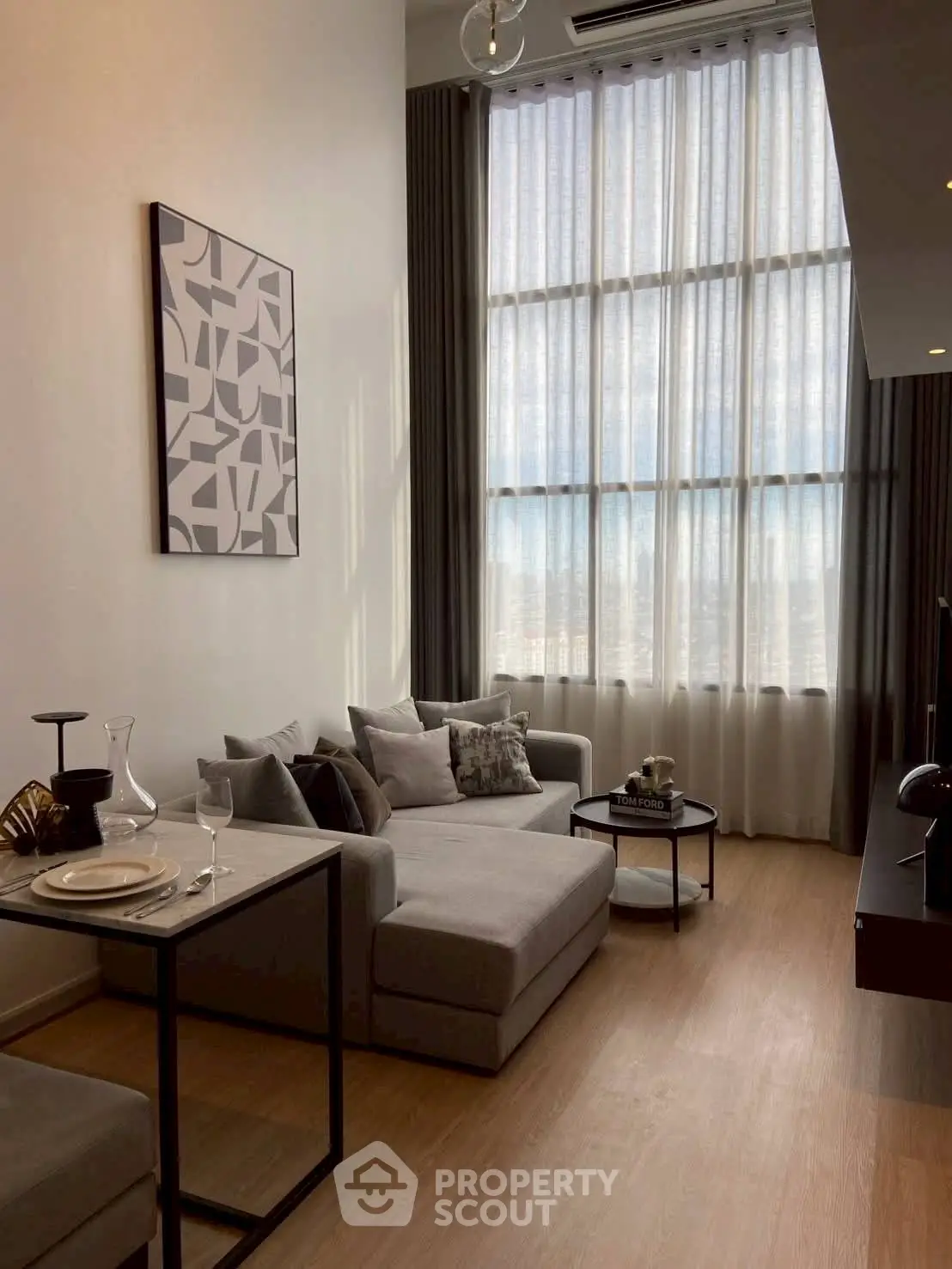 Stylish modern living room with high ceilings and large windows