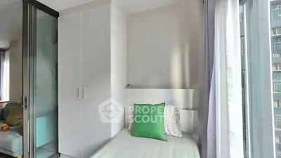 Cozy bedroom with modern design and large window for natural light