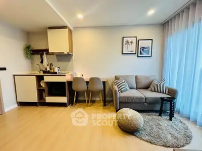 Modern open-layout living room with cozy seating and stylish kitchen area
