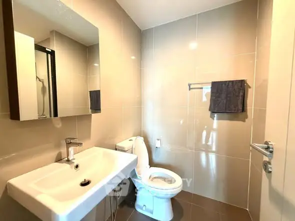 Modern bathroom with sleek fixtures and neutral tiles