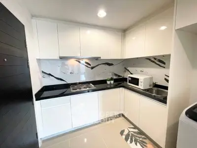 Modern kitchen with sleek white cabinets and marble backsplash