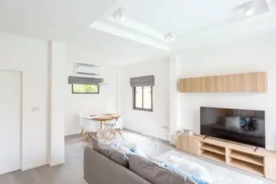 Modern living room with sleek furniture and natural light, perfect for relaxation and entertainment.