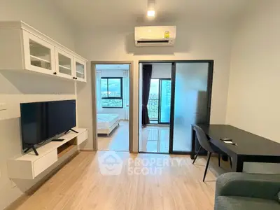 Modern apartment interior with living room, bedroom, and city view, featuring sleek furniture and air conditioning.