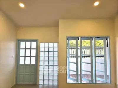Bright room with large windows and glass door, perfect for natural light lovers.