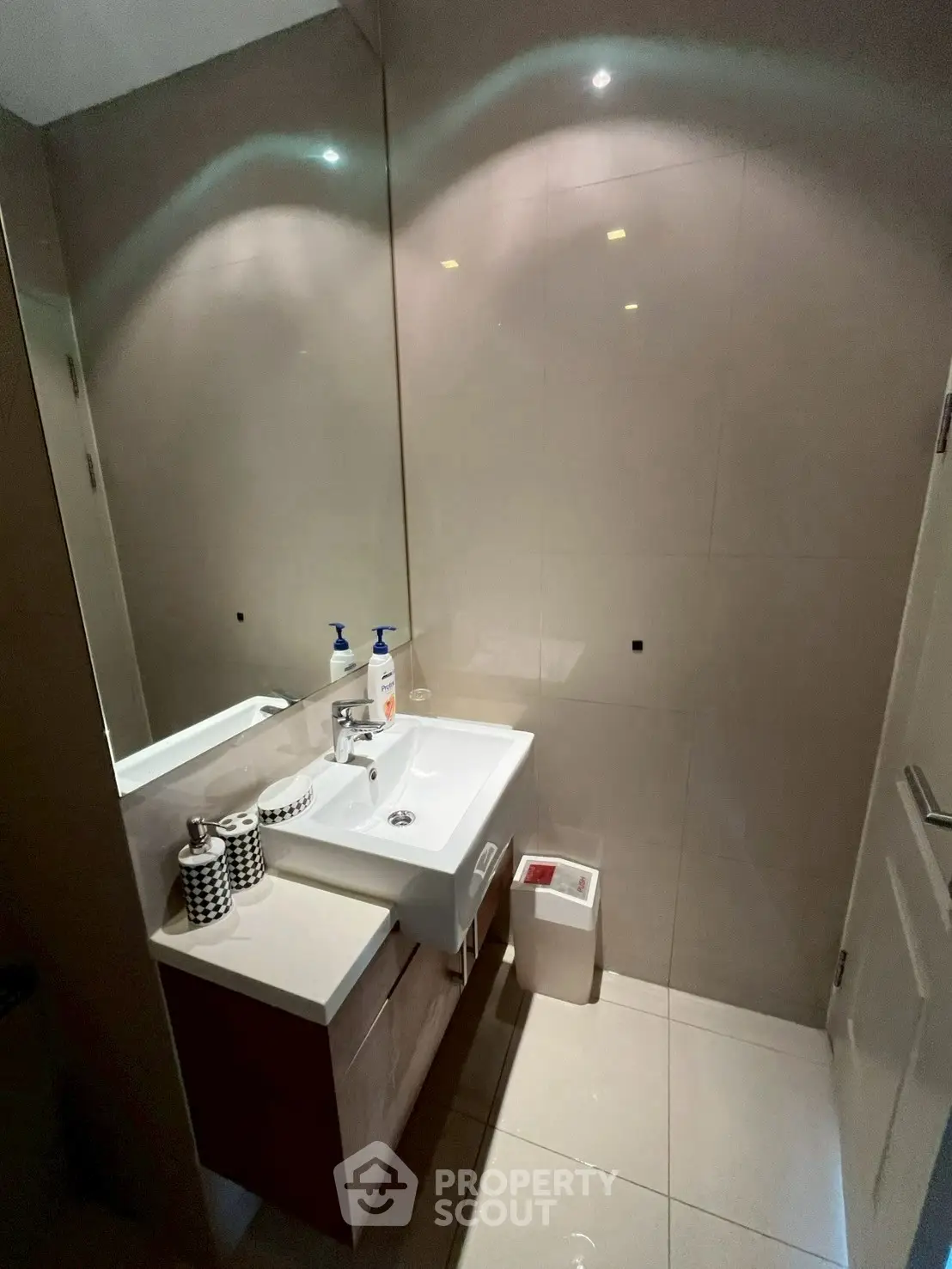 Modern bathroom with sleek sink and stylish accessories in a contemporary home.