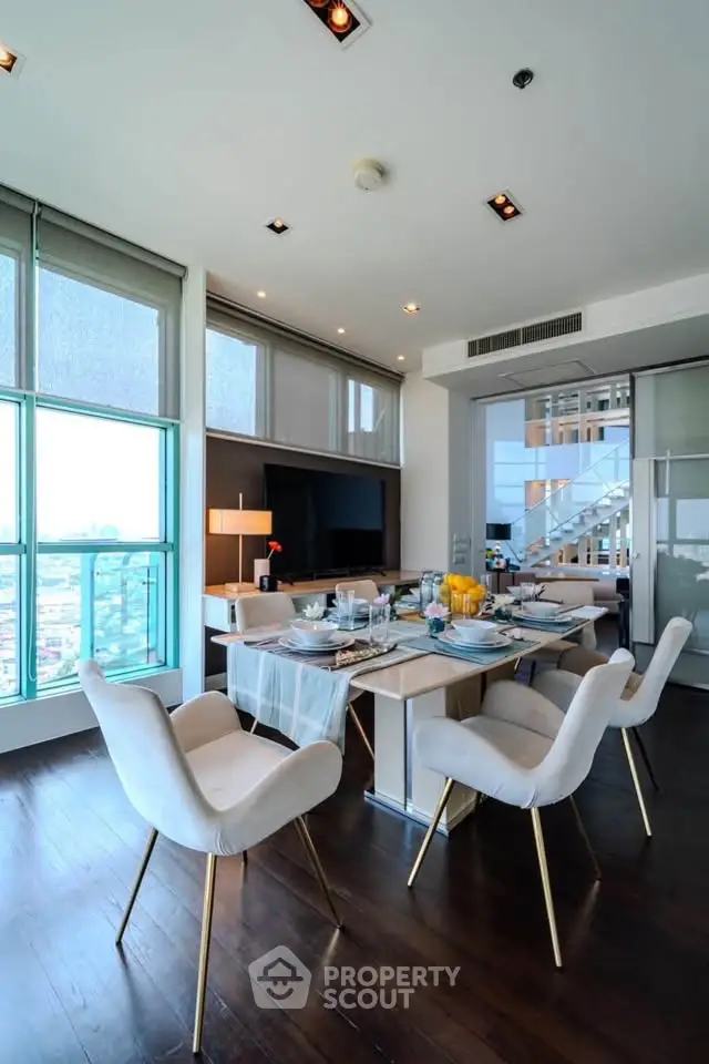 Luxurious dining area with modern decor and stunning city view, perfect for entertaining guests.