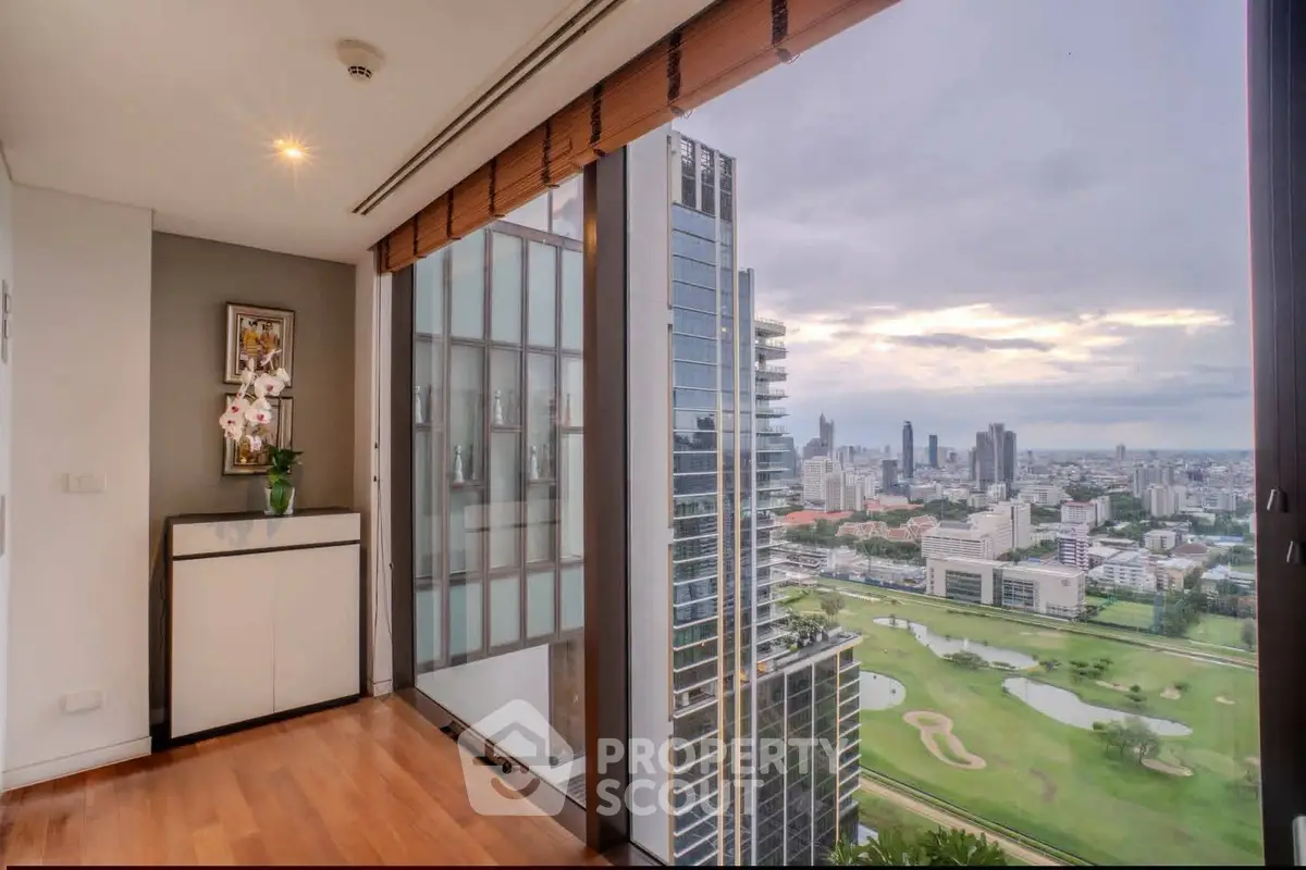 Luxurious high-rise apartment with stunning city and golf course views, featuring elegant wooden flooring and modern decor.