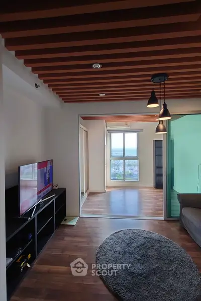 Modern living room with wooden ceiling and large window offering city view