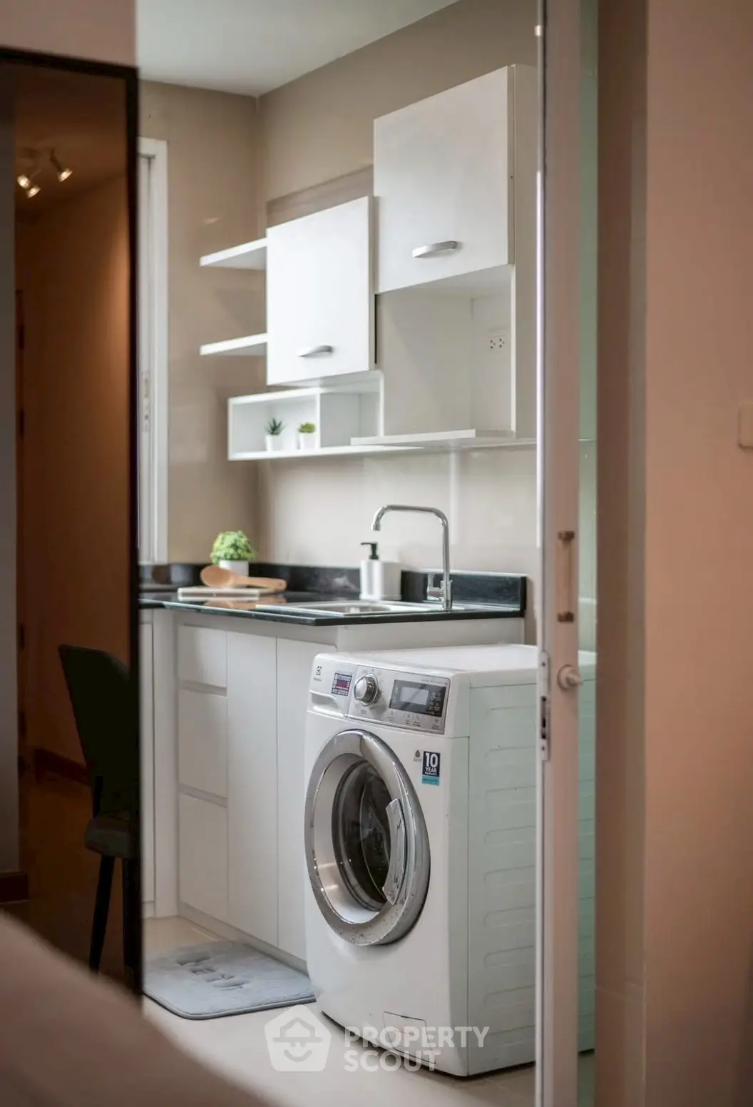 Modern kitchen with sleek cabinetry and integrated washing machine