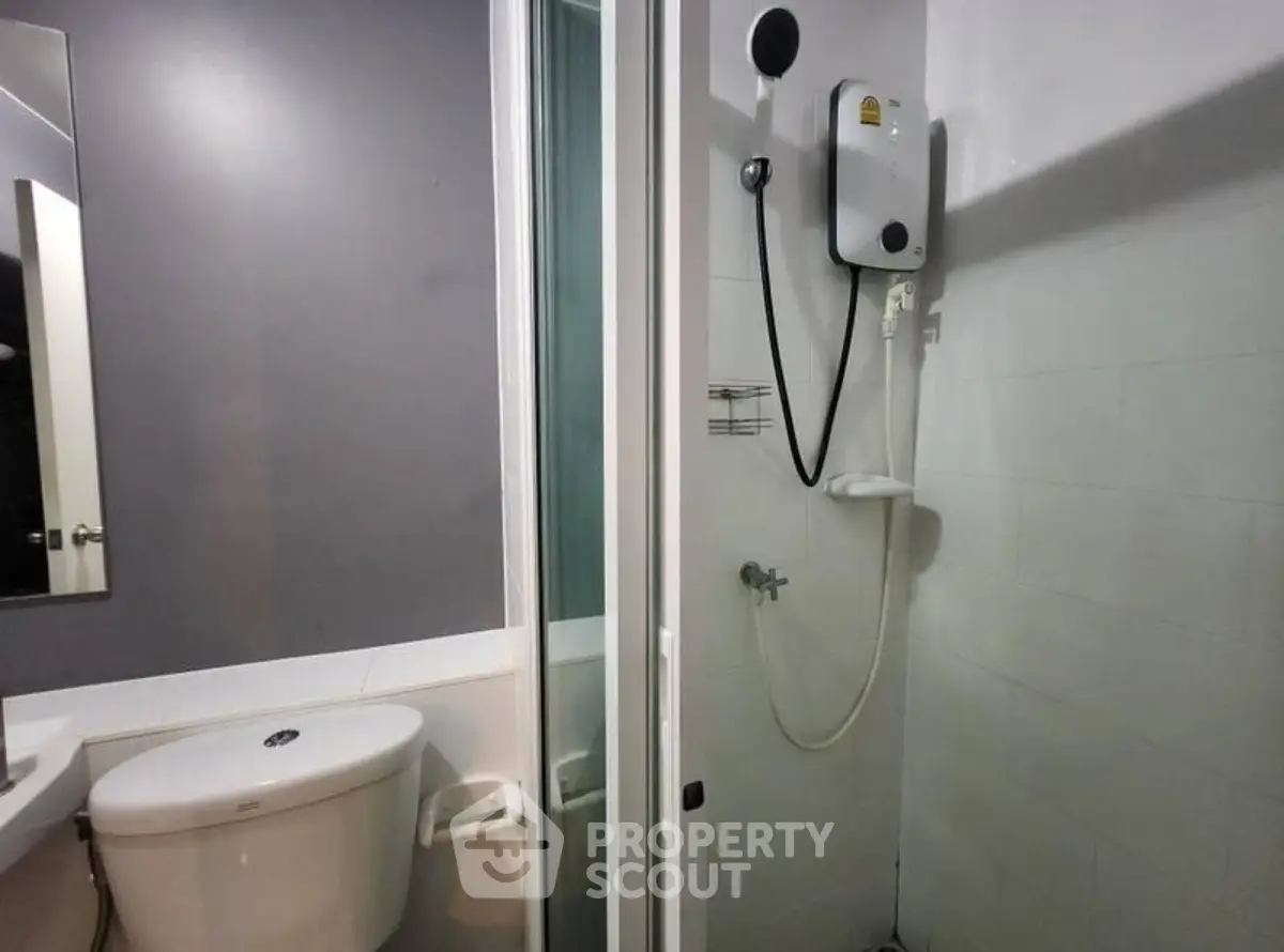 Compact bathroom with shower and toilet in modern apartment