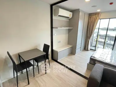 Modern studio apartment with balcony and sleek furnishings