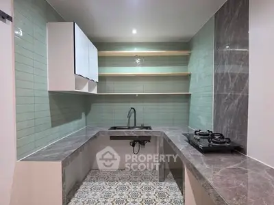 Modern kitchen with sleek countertops and gas stove in stylish apartment