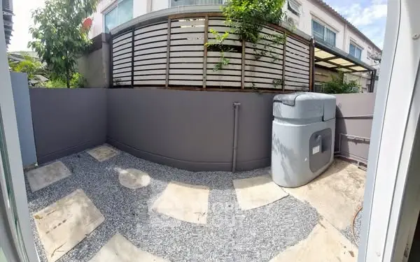 Charming small garden area with modern design and privacy fence.
