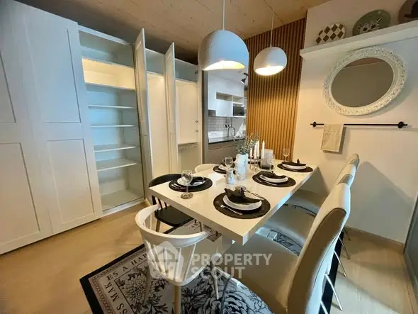 Stylish dining area with elegant table setting and modern lighting in a cozy home interior.