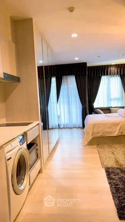 Modern bedroom with washing machine and large windows