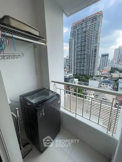 High-rise condo balcony with washing machine and city view