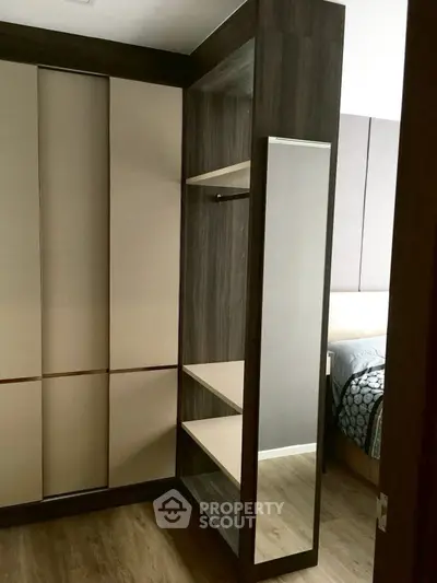 Modern bedroom with stylish walk-in closet and elegant design