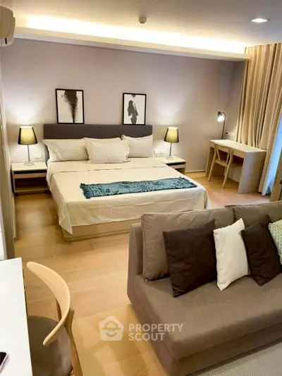 Modern bedroom with stylish decor and cozy seating area
