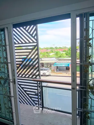 Charming balcony view with decorative railing and street scenery