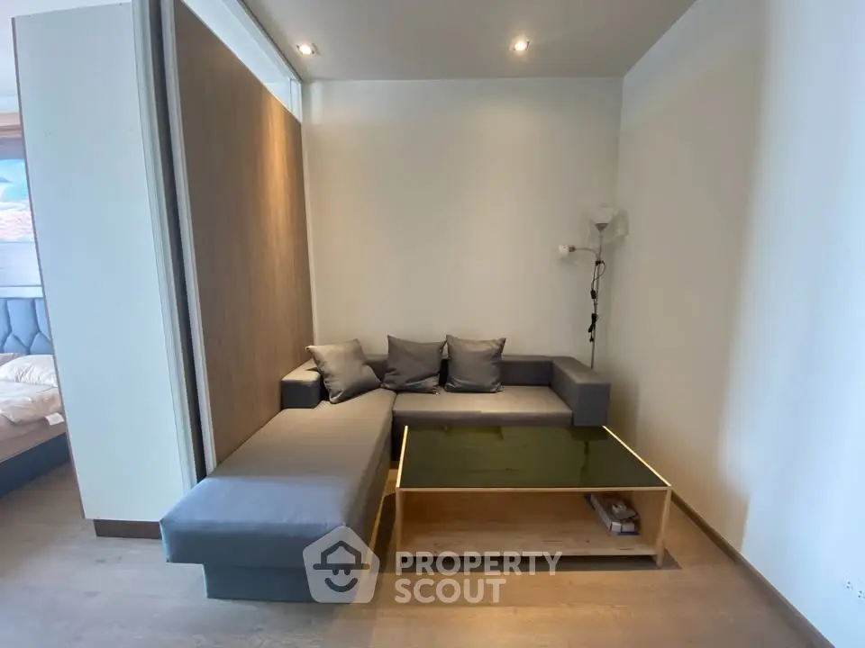 Modern living room with sleek gray sectional sofa and stylish coffee table