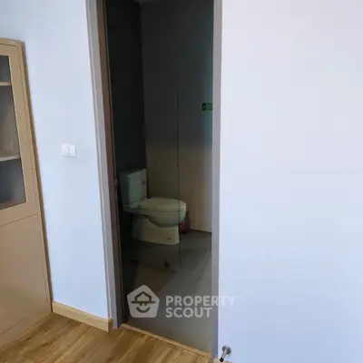 Modern bathroom with sleek design and glass door entry