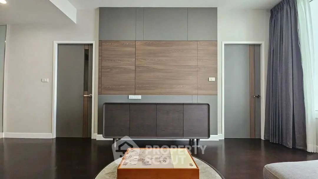 Modern living room with sleek wooden paneling and stylish furniture