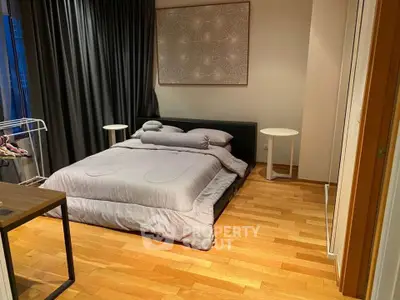 Cozy modern bedroom with wooden flooring and stylish decor