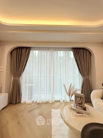 Elegant living room with large window and stylish decor
