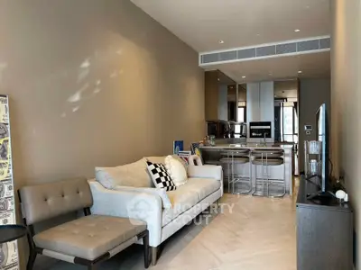 Modern living room with stylish furniture and open kitchen layout in a contemporary apartment.