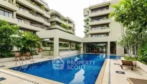 Luxurious residential complex with a stunning outdoor pool and lush greenery.