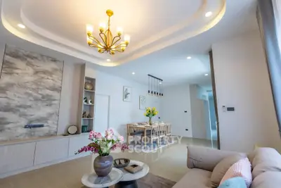 Elegant living and dining area with modern chandelier and stylish decor