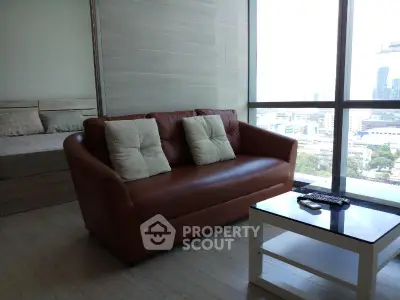 Modern living room with leather sofa and city view, perfect for urban living.
