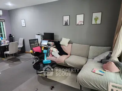 Cozy living room with modern decor and comfortable seating in a stylish apartment.