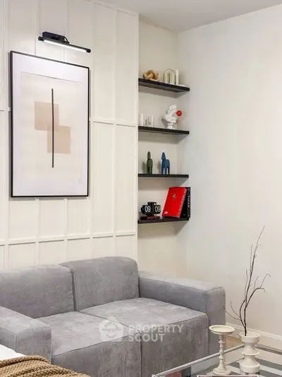 Modern living room with stylish gray sofa and contemporary wall art, perfect for urban living.
