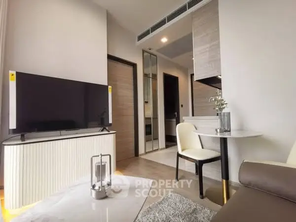 Modern living room with sleek TV setup and cozy dining area
