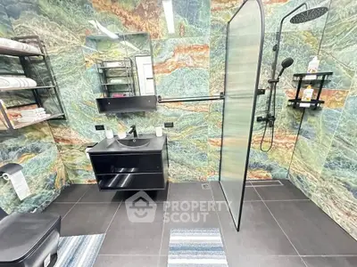 Luxurious modern bathroom with vibrant marble walls and sleek black fixtures.
