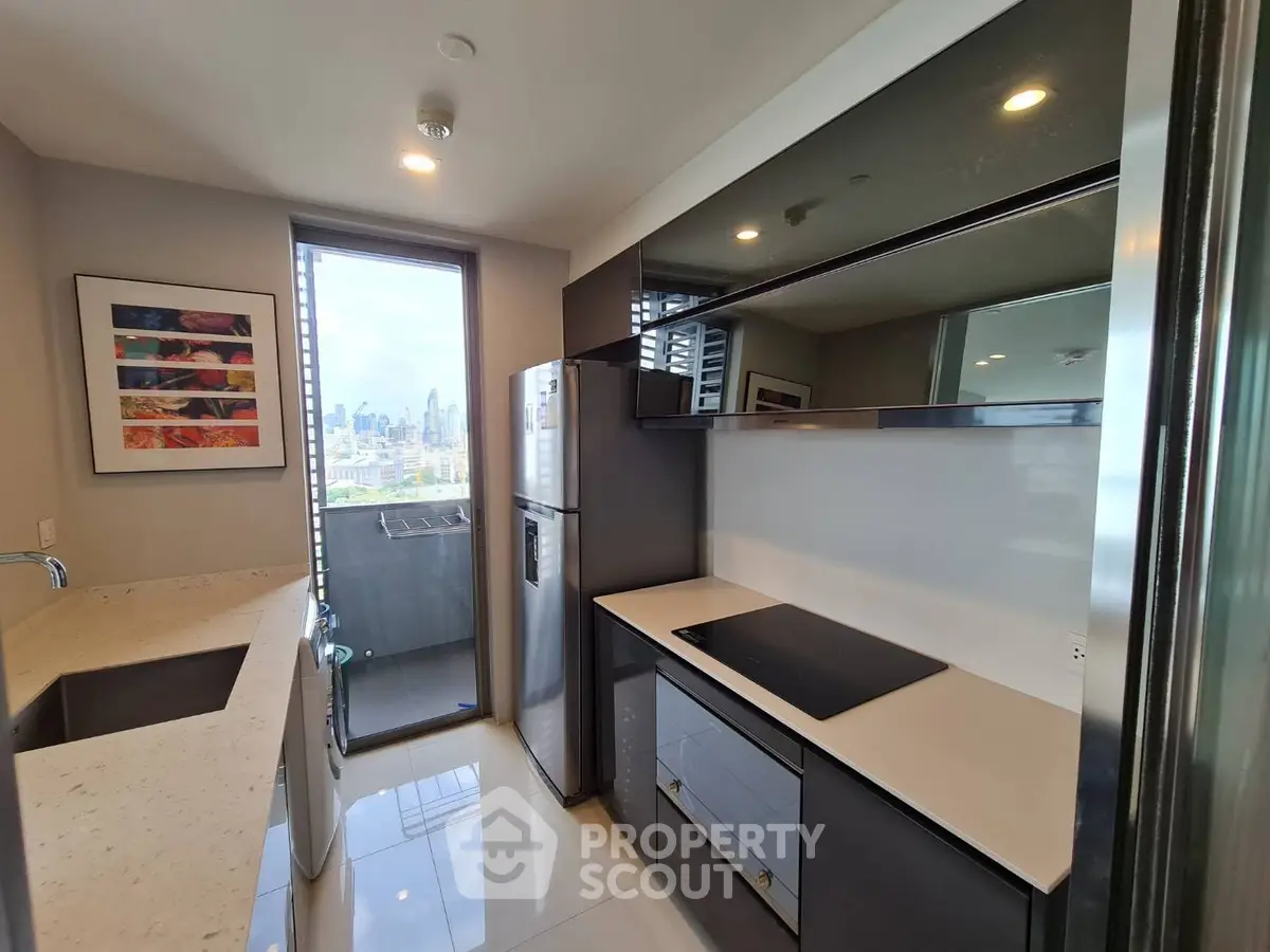 Modern kitchen with sleek appliances and city view from window