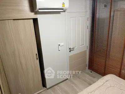 Cozy bedroom with modern air conditioning and wooden wardrobe