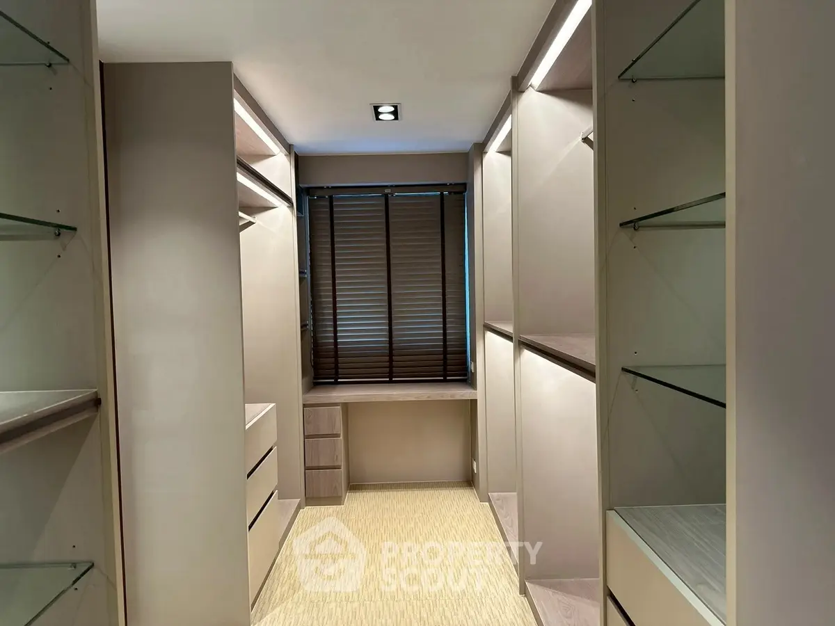 Luxurious walk-in closet with ample shelving and natural light
