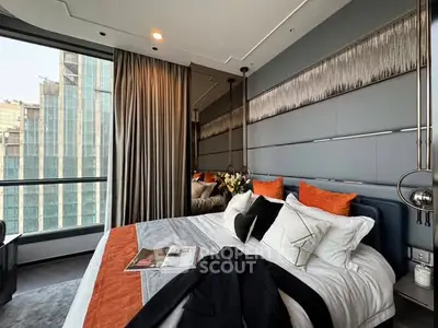 Luxurious modern bedroom with city view, elegant decor, and plush bedding in high-rise apartment.