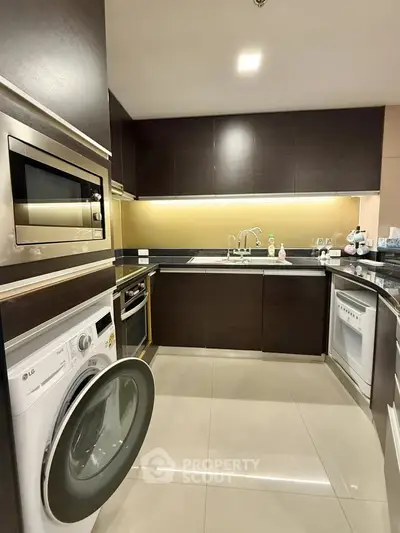 Modern kitchen with sleek cabinetry, built-in appliances, and open layout for stylish cooking experience.