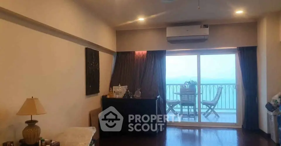 Spacious living room with balcony offering stunning sea view, perfect for relaxation and entertaining.