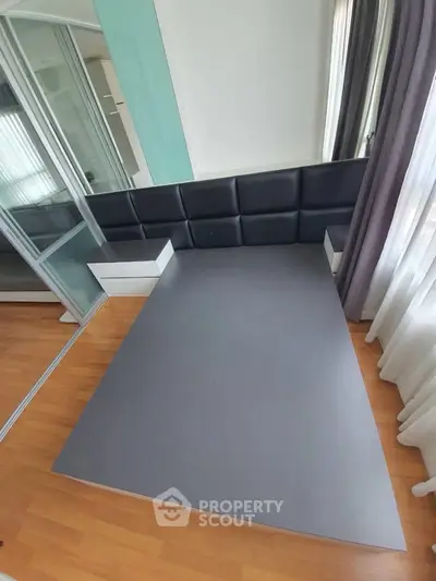 Modern bedroom with sleek platform bed and mirrored closet doors
