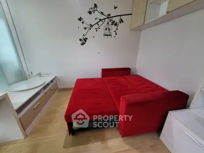 Cozy living room with vibrant red sofa bed and modern decor