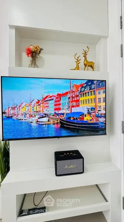 Modern living room with wall-mounted TV and stylish decor