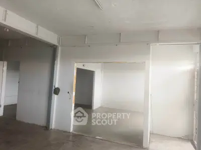 Spacious unfinished interior space with potential for customization in real estate property.
